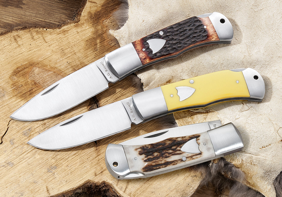 Hollow ground drop point hunting pocket knife in yellow delrin or jigged bone